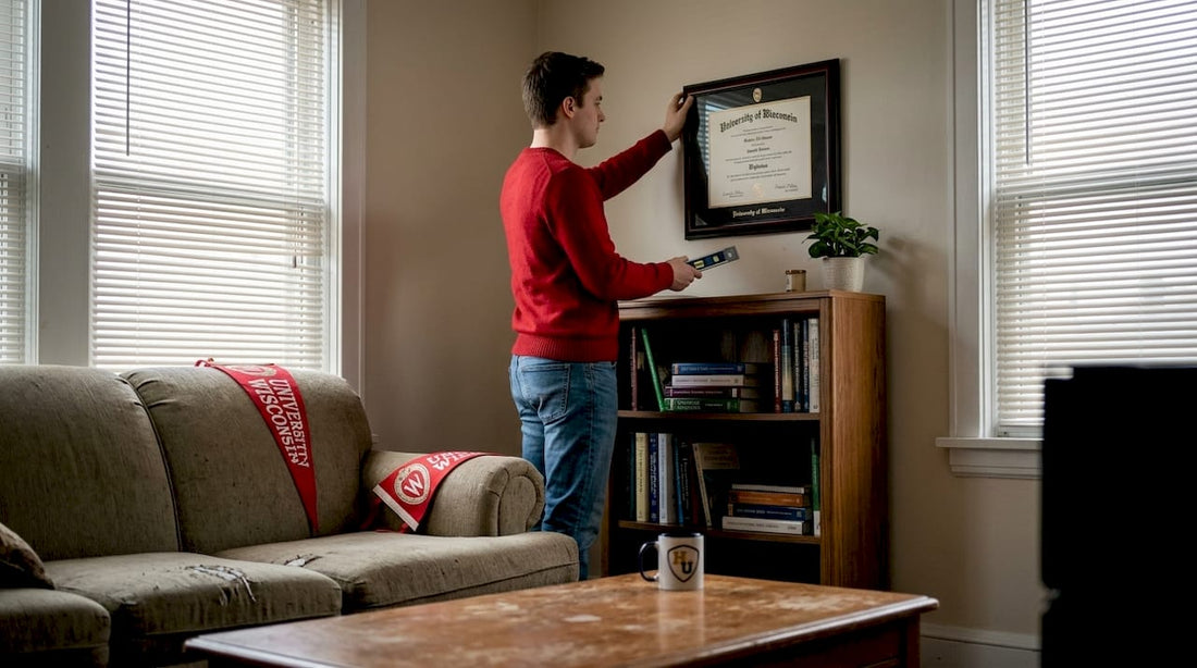 Graduate hanging University of Wisconsin diploma frame